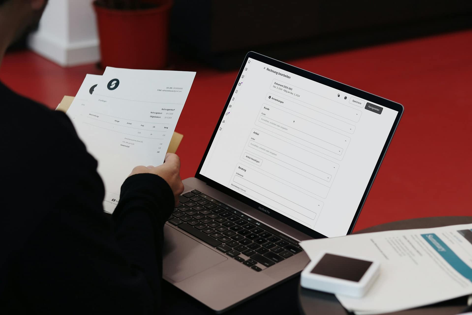 A desk with a laptop and paperwork